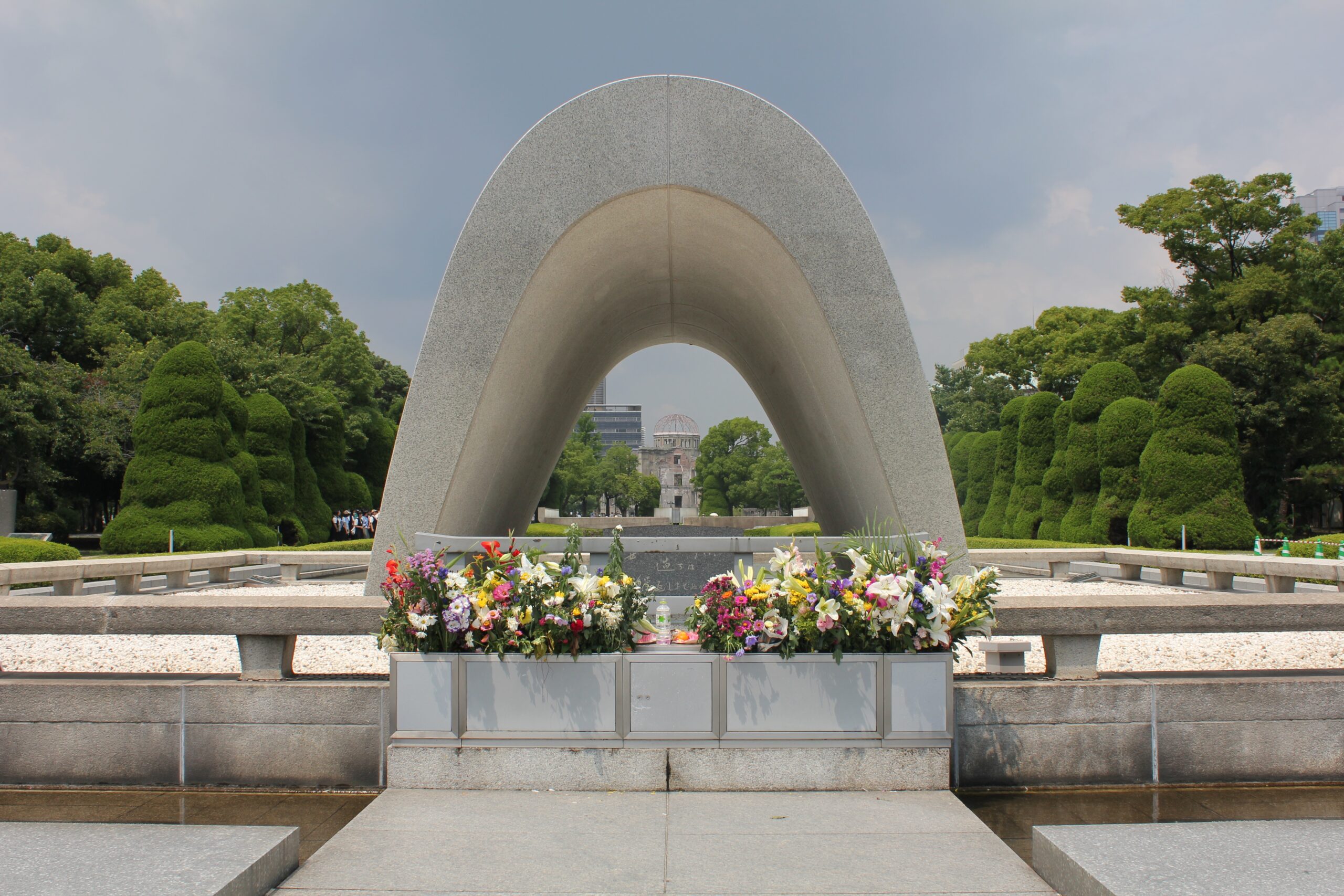 Cenotaph at the Hiroshima Peace Memorial Park in 2011, with the A-Bomb Dome in the background