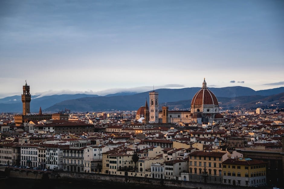 Stunning aerial view of Florence featuring the iconic Duomo and Palazzo Vecchio at sunset.