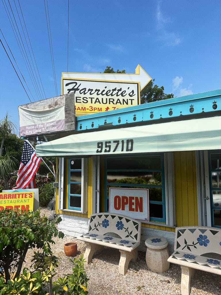 Exterior of Harriette's Restaurant with vibrant colors and an open sign.